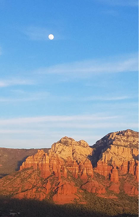 Sedona mountains in Stifel blue with orange circle around the moon